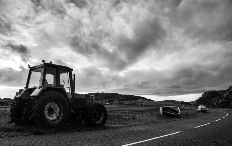 A Hebridean welcome--a tractor and some boats on land, empty roads and turbulent skies, that followed us where we went on these mysterious isles. 